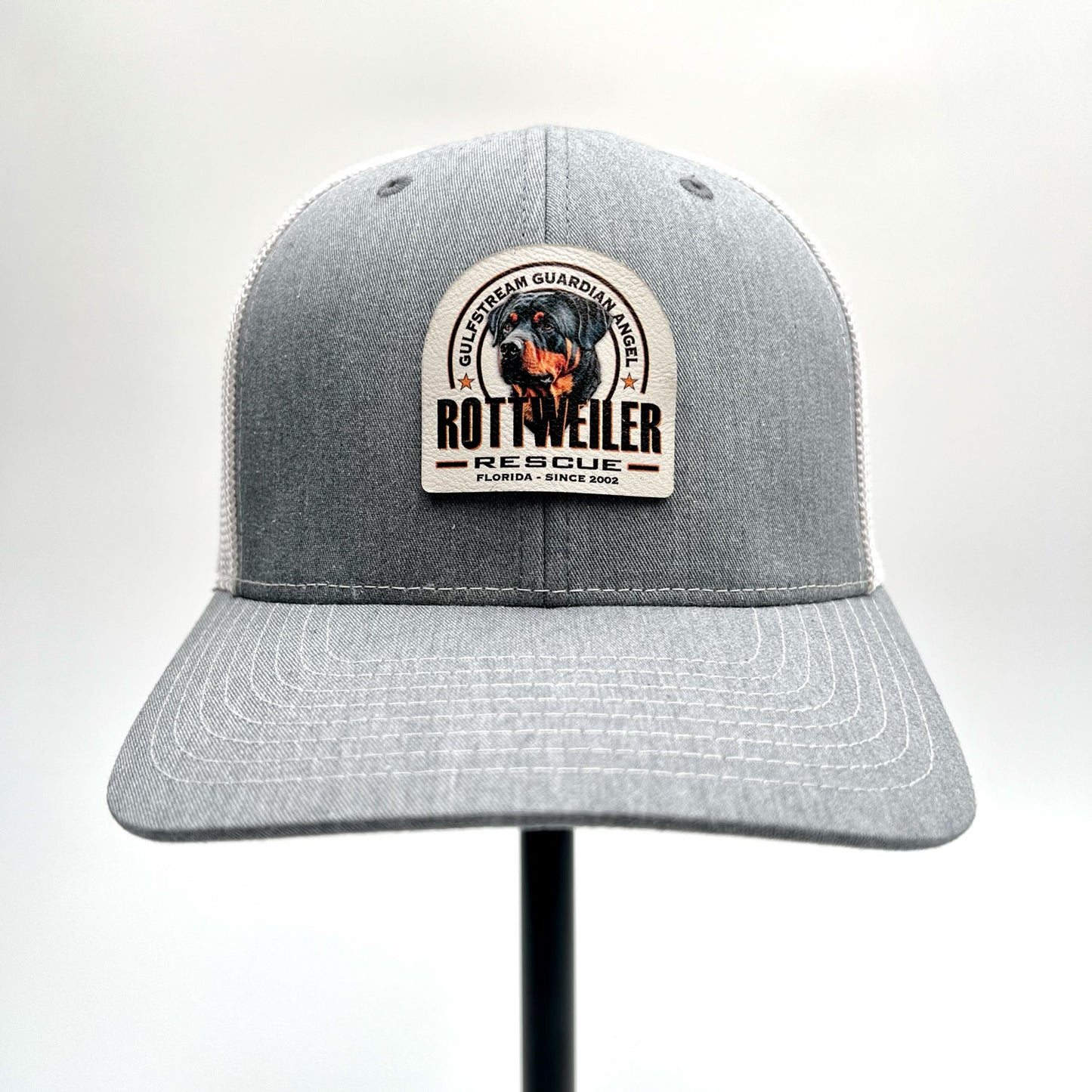 Gulfstream Guardian Angel Rottweiler Rescue heather gray and white trucker hat with a full color patch.