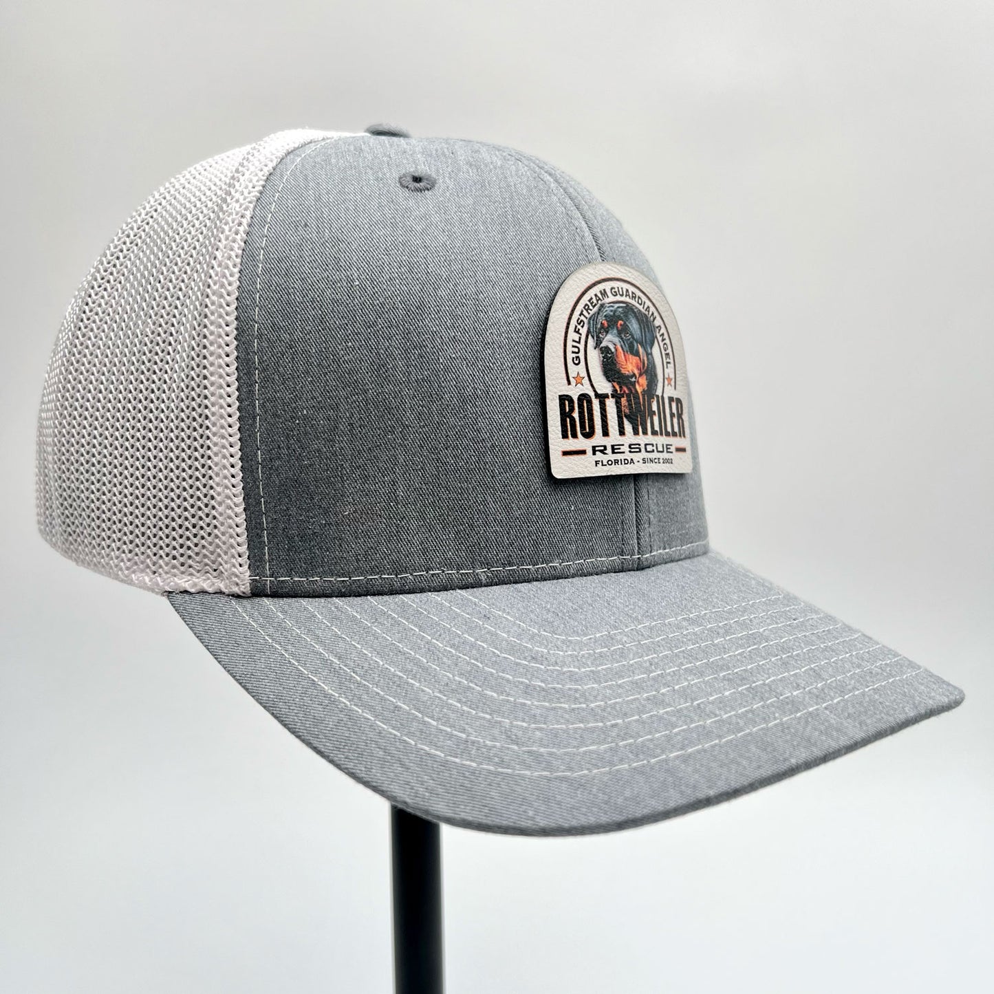 Gulfstream Guardian Angel Rottweiler Rescue heather gray and white trucker hat with a full color patch.