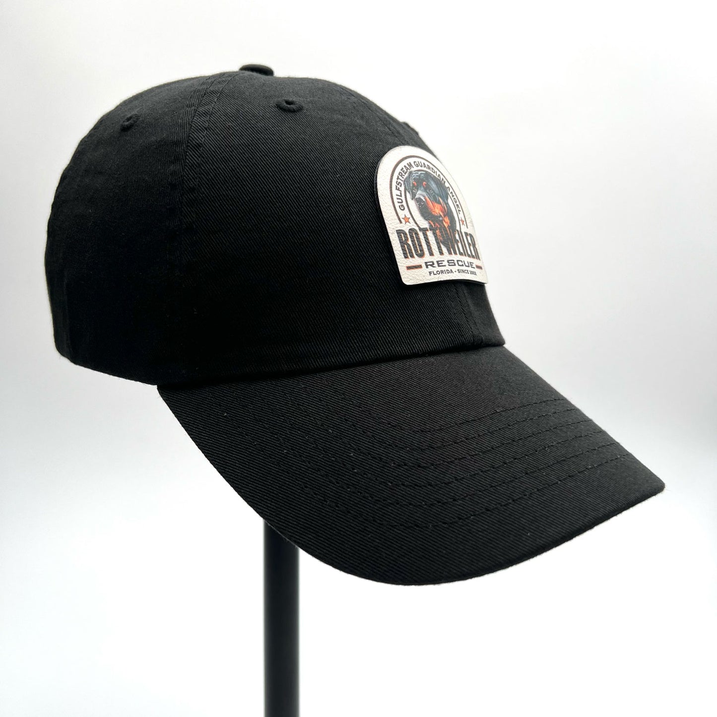 Gulfstream Guardian Angel Rottweiler Rescue black dad hat with a full color patch.
