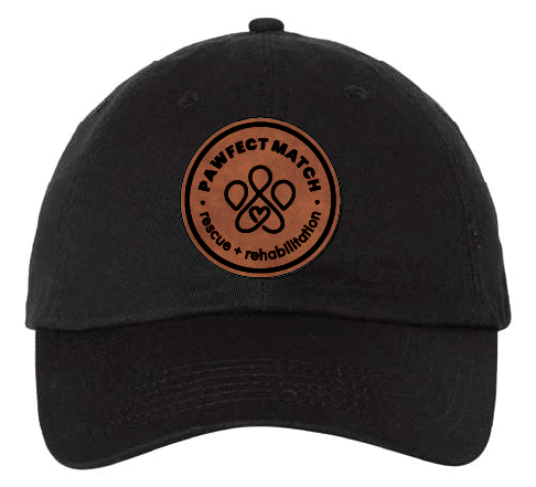 Unstructured dad hat in black, featuring the Pawfect Match revue logo on brown leatherette with black engrave