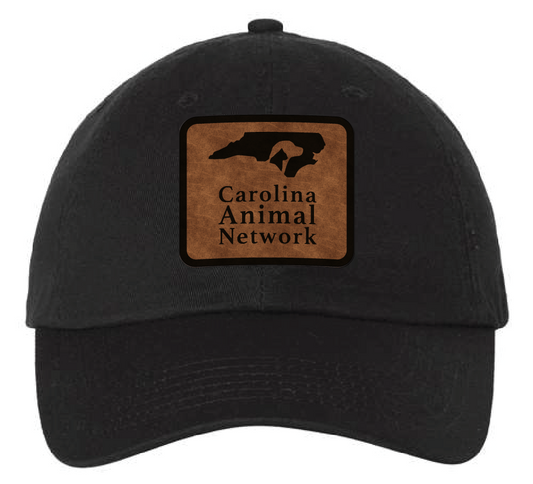 Black dad hat featuring the Carolina Animal Network logo in a brown and black leatherette patch. Front view.