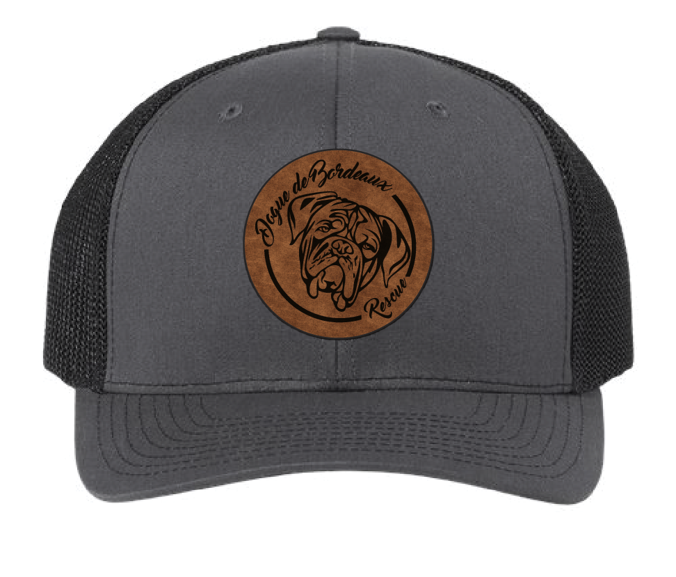 Charcoal/Black trucker hat featuring the Dogue de Bordeaux Rescue, Inc. logo in a brown and black leatherette patch. Front view.