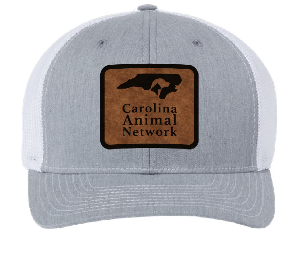 Heather gray/white trucker hat featuring the Carolina Animal Network logo in a brown and black leatherette patch. Front view.