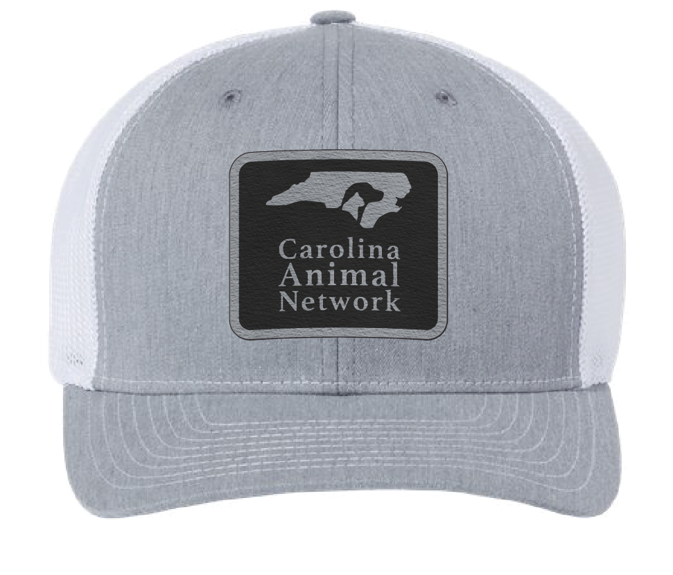 Heather gray/white trucker hat featuring the Carolina Animal Network logo in a black and silver leatherette patch. Front view.