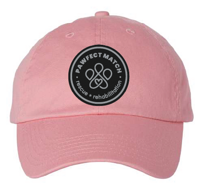 Unstructured dad hat in pink, featuring the Pawfect Match revue logo on Black leatherette with silver engrave