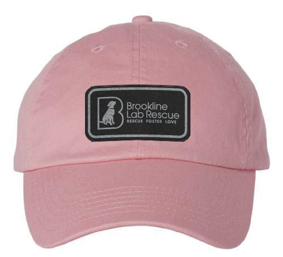 Pink dad hat featuring the Brookline Lab Rescue logo in a black and silver leatherette patch. Front view.