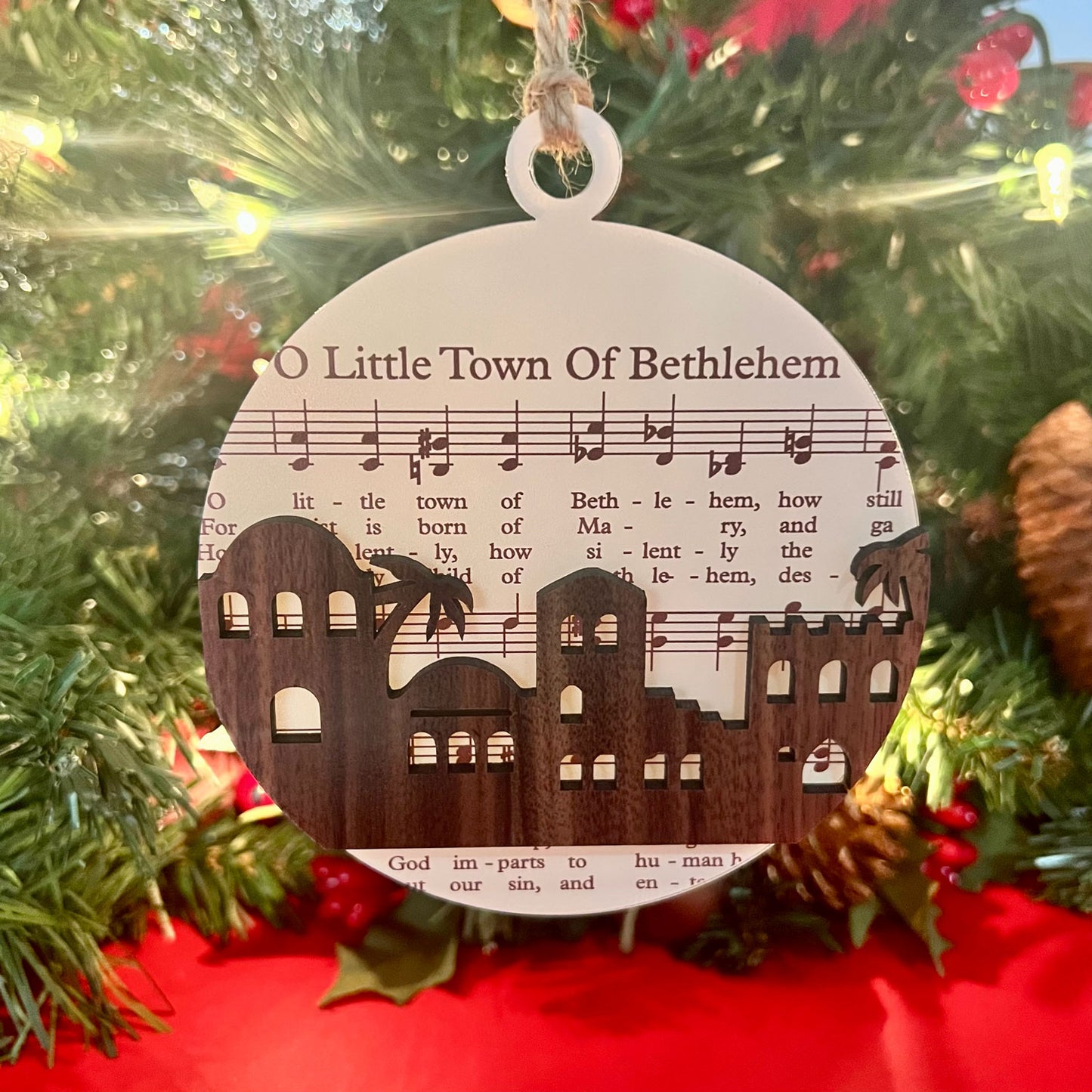 The Biblical Christmas Story Ornament: Sheet Music with town silhouette and a palm tree: "O Little Town of Bethlehem."