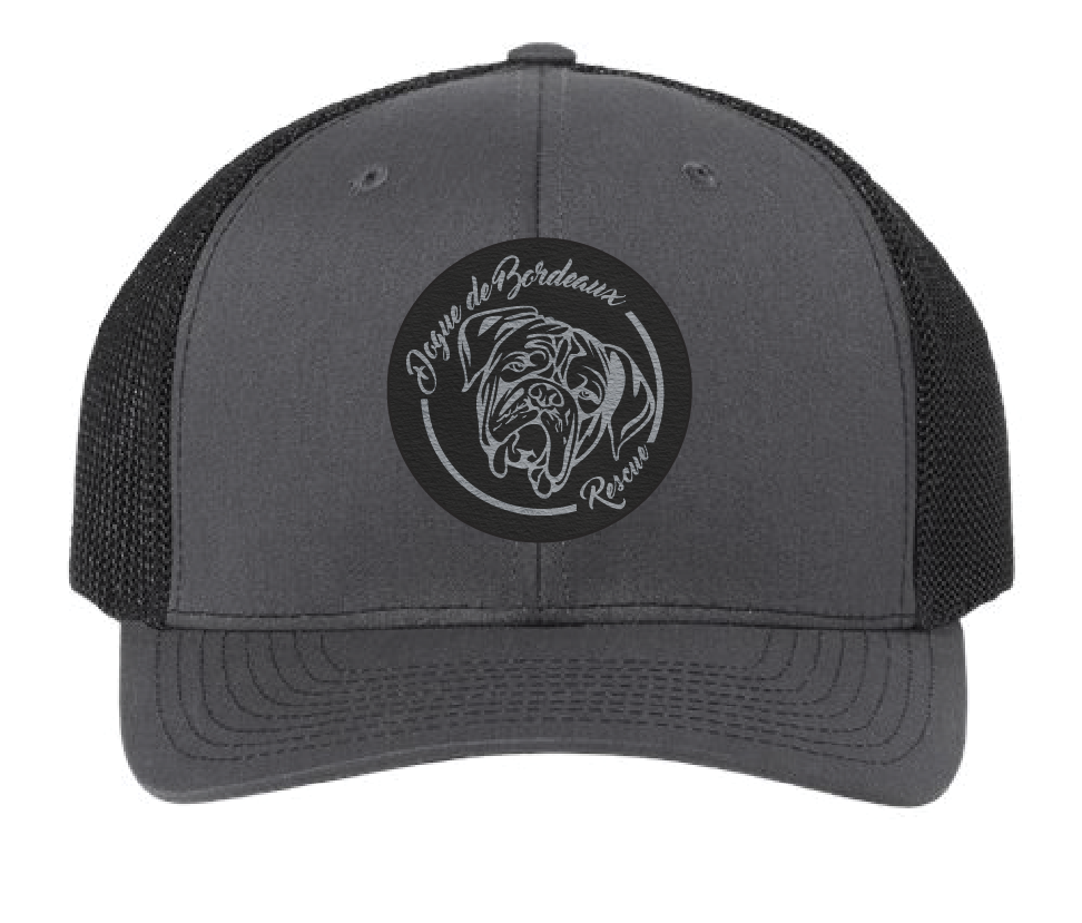 Charcoal/Black trucker hat featuring the Dogue de Bordeaux Rescue, Inc. logo in a black and silver leatherette patch. Front view.