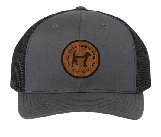 Black/Charcoal Snake River Animal Shelter trucker patch hat with brown and black patch.