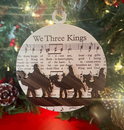 The Biblical Christmas Story Ornament: Sheet Music with three kings riding camels: "We Three Kings"